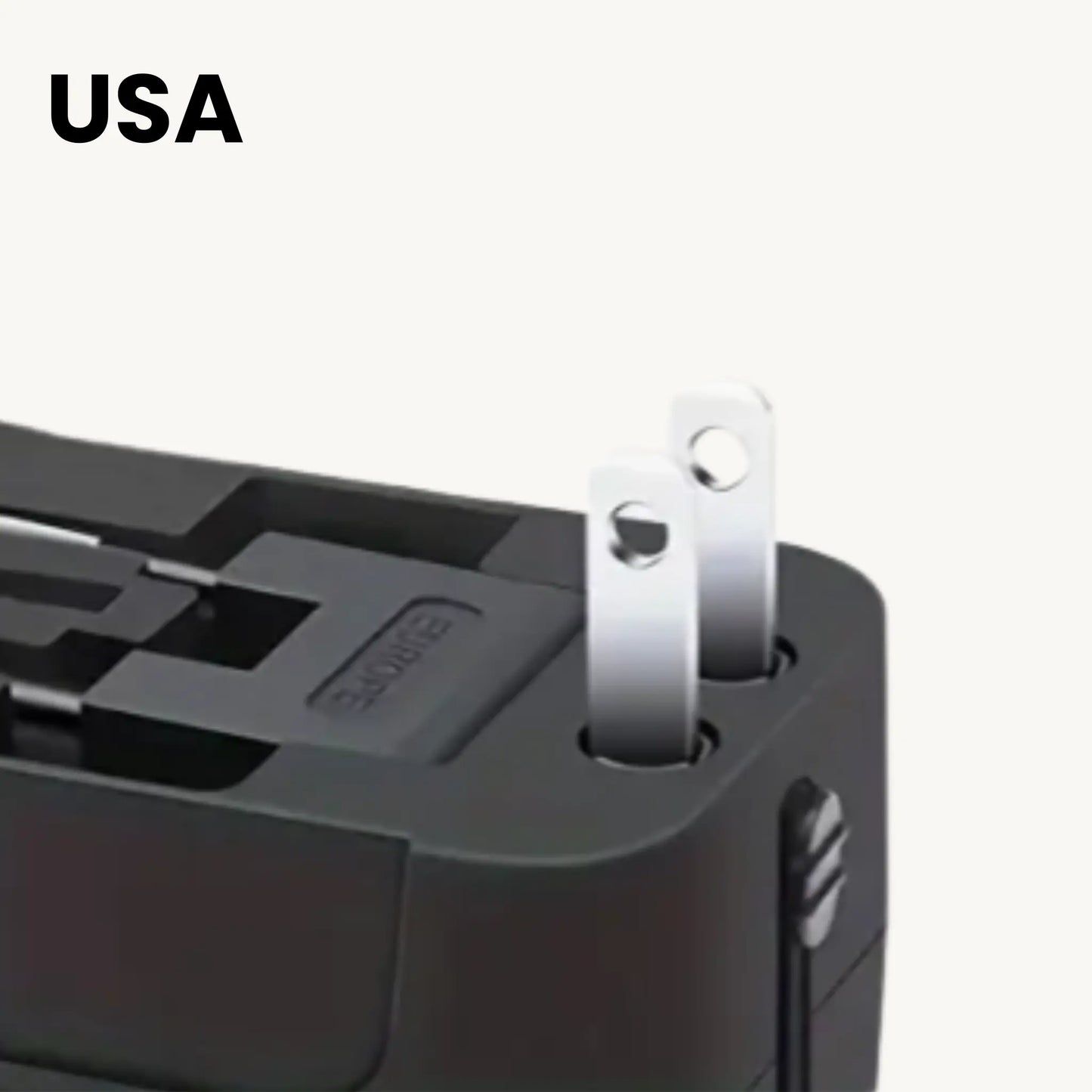 Close-up of ADAPTGO world adapter plug for USA, suitable for charging devices internationally.