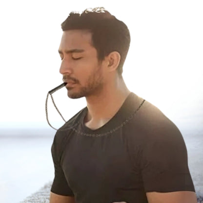 Man practicing mindful breathing with RESPIRA breathing necklace, promoting relaxation and stress relief.