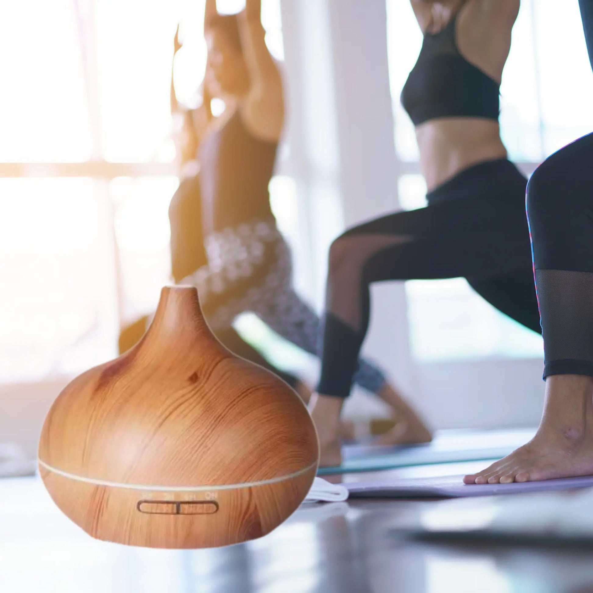 CALMARA diffuser in a serene yoga setting, enhancing relaxation with aromatherapy and soft lighting.