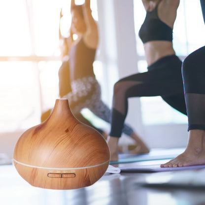 CALMARA diffuser in a serene yoga setting, enhancing relaxation with aromatherapy and soft lighting.